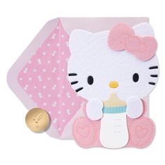 a hello kitty baby pacifier and its packaging on a white background with a gold coin