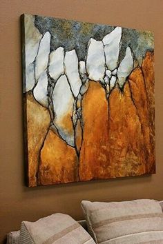 a painting hanging on the wall above a bed