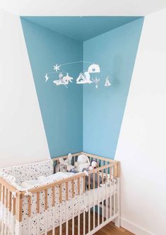 a baby's room painted in blue and white