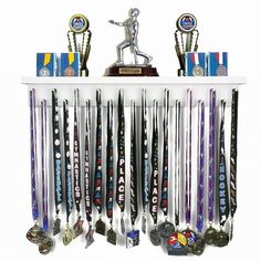 an assortment of trophies and medals on a white shelf