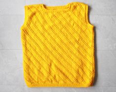 Vintage yellow wool knit sleeveless sweater unisex vest top. Scoop neck, sleeveless, no lining. Material feels like wool or some wool blend. Measured laying flat (please note, that as knitted item, it stretches): 26'' / 66 cm long 23'' / 58 cm armpit to armpit Great vintage condition. Sleeveless Yellow Sweater Vest For Fall, Yellow Sleeveless Vest For Fall, Knitted Crew Neck Vest, Yellow Knit Top For Winter, Winter Yellow Knit Top, Spring Crew Neck Knitted Vest, Spring Knitted Crew Neck Vest, Cotton Sleeveless Tank Top, Cotton Knit Sleeveless Vest