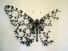 a large group of birds flying in the air with their wings spread out to form a butterfly