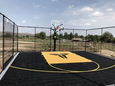 an empty basketball court with a hoop in the middle