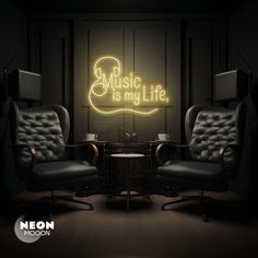 two leather chairs sitting in front of a neon sign that says music is my life