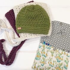 three crocheted hats are laying next to each other