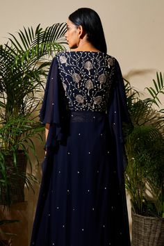 Midnight blue long kurta with floral embroidered detail and flared sleeves. Comes with flared skirt.
Components: 2
Fabric: Pure Georgette, Satin Lining, Cotton Silk
Neckline: Boat
Sleeve Length: Three quarter 
Color: Blue
Embroidered
Embroidered  skirt - Aza Fashions Intricate Embroidered Dress With Cape Sleeves For Eid, Cape Sleeve Dress With Intricate Embroidery For Eid, Intricate Embroidery Dress With Cape Sleeves For Eid, Intricate Embroidery Cape Sleeve Dress For Eid, Blue Embellished Dress With Cape Sleeves, Eid Floral Embroidered Dress With Cape Sleeves, Traditional Dresses With Floral Embroidery And Cape Sleeves, Blue Cape Sleeve Sets For Reception, Blue Anarkali Dress With Cape Sleeves