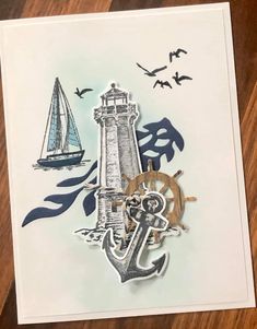 a card with an anchor, lighthouse and sailboat on it's front side