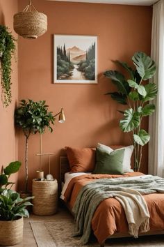 a bedroom with orange walls and plants in the corner, along with a bed that has an orange blanket on it