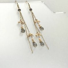 "Our super-glam version of the Waterfall Earring. We have chosen three lengths of chain in either 14K Gold Fill or Sterling Silver and interspersed them with delicate bundles of light blush pink Seed Pearls and a single Rondelle of faceted Smoky Quartz at the top. The chains are then finished with a single Seed Pearl and a faceted tear drop of Smoky Quartz. The effect is nothing less than stunning! Each gemstone is hand wrapped in either 14K Gold-Filled or Sterling Silver Wire before added to th Glamorous Dangle Pearl Drop Jewelry, Elegant Long Drop Crystal Earrings With Dangling Beads, Elegant Teardrop Crystal Earrings With Dangling Beads, Glamorous Sterling Silver Dangle Chandelier Earrings, Pearl Drop Dangle Linear Earrings, Nickel Free Long Drop Chandelier Earrings For Party, Dangle Crystal Earrings For Evening, Crystal Dangle Earrings With Charms For Party, Elegant Teardrop Earrings With Dangling Beads Gift