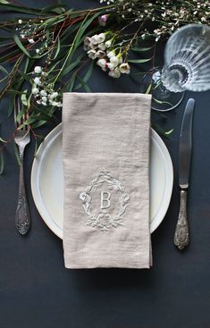 a place setting with napkins and silverware