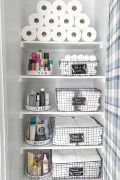 an organized closet with toilet paper and baskets