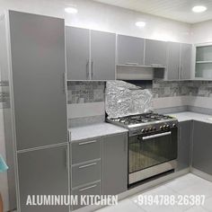 a kitchen with stainless steel cabinets and white tile flooring is shown in this image