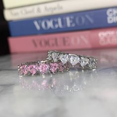 This beautiful, shiny baguette cubic zirconia diamond ring comes in two different styles: PINK HEARTS SILVER/CLEAR HEARTS  Can be bought together as a set or alone. (BUY MORE SAVE MORE) - Iced out ring / Baguette Ring / Eternity Ring / Cz ring / Diamond Ring / Heart Ring Available in sizes 5 to 9 (US), ready to ship. Metal: Real, Sterling Silver Stone: Cubic Zirconia (best alternative to real diamond) Metal Purity: .925 Sterling Silver Rhodium plated for tarnish resistance and luster Setting: Et Pink Cubic Zirconia Eternity Band For Anniversary, Pink Cubic Zirconia Eternity Band As Gift, Heart Eternity Ring, Heart Ring Box, Wedding Stone, Ring Baguette, Cheap Engagement Rings, October Birthstone Rings, Gold Heart Ring