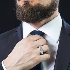 a man in a suit adjusting his tie