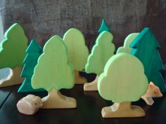 small wooden trees are lined up on a table