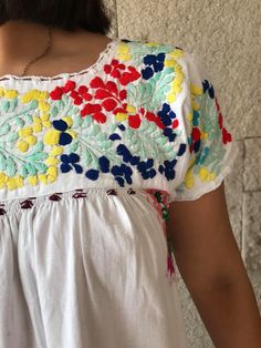 "Elegant dress and colourful hand-embroidery. Perfect for mexican wedddings, mexican parties, etc. Made in the 80's Loose fit In perfect conditions. Fits size Small Measurements taken flat: Armpit to armpit 20 1/2\" Bottom hem width 29 1/2\" Shoulder to bottom hem 49\"" Summer Bohemian Embroidered Dress With Floral Print, Bohemian Multicolor Embroidered Summer Dress, Summer Embroidered Dress With Yoke, Summer Embroidered Dress With Yoke Detail, Summer Dresses With Geometric Embroidery And Short Sleeves, Summer Bohemian Multicolor Embroidered Dress, Short Sleeve Dresses With Geometric Embroidery For Summer, Short Sleeve Embroidered Floral Dress For Vacation, Summer Folk Style Embroidered Dress With Floral Print