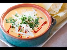 a bowl of soup with tortilla chips on the side