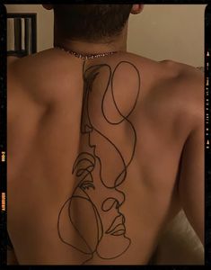 a man with a tattoo on his back