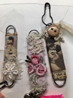 three different key chains with charms attached to them