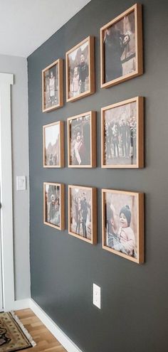 a wall with many pictures hanging on it