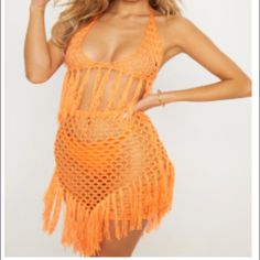 a woman wearing an orange crochet swimsuit