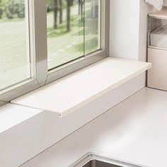 a window sill sitting next to a kitchen sink