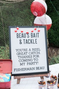 there is a sign on the table that says beaus bat & tackle you're a reel great catch coming to my party