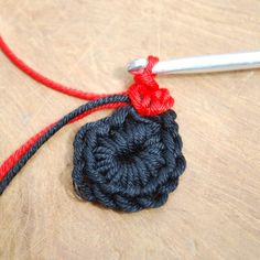 a crochet flower is being worked on