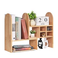 a book shelf with books and other items on it, including a plant in a vase