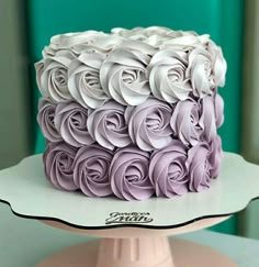 there is a cake with purple icing on the top and white frosting on the bottom