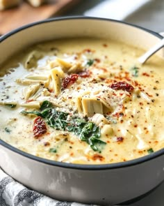 a close up of a bowl of soup with broccoli and cheese in it