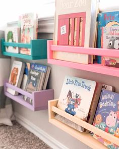 children's books are lined up on shelves in a room with carpeted flooring