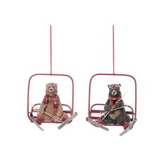 two teddy bears riding on skis in a sleigh ornament set