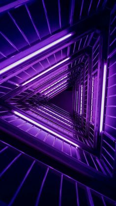 an abstract photo with purple lighting in the center and lines on the sides that make it look like they are going through a tunnel