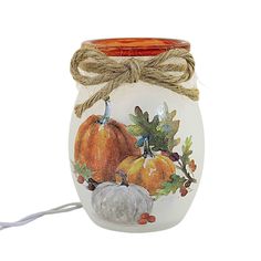 a glass jar with pumpkins and acorns painted on the side, tied to a string