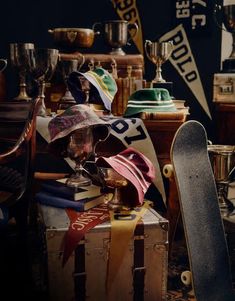 an assortment of hats, scarves and skateboards are piled on top of each other