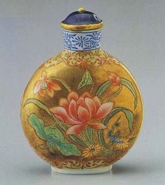 an ornate vase with flowers painted on the outside and gold trimming around the top