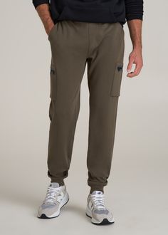 About Our Extra-Long Men's Joggers These tall men's jogger pants have all the comfort of your favorite sweats with the function of a pair of cargo pants. We know how hard it is to find comfy clothes when you're a tall guy, which is why we crafted this pair specifically for your height. The extra-long inseam will end right below the ankle where joggers are supposed to, so you can leave the days of awkward lengths behind. They have a modern fit with cargo pockets on either side featuring zipper cl Khaki Sweatpants With Pockets For Loungewear, Sports Khaki Sweatpants With Pockets, Sporty Khaki Joggers With Pockets, Khaki Sweatpants With Pockets For Athleisure, Outdoor Sweatpants With Cargo Pockets, Khaki Cotton Cargo Pants For Sports, Khaki Cargo Pants With Side Pockets For Loungewear, Sporty Khaki Sweatpants With Pockets, Outdoor Cargo Style Joggers