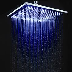 the rain shower head is blue and has white lights on it's sides,