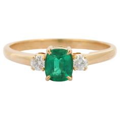 Emerald Gemstone Ring Set in 18K Gold with Diamonds featuring natural emerald of 0.9 carats and diamonds of 0.1 carats. The gorgeous handcrafted ring goes with every style. Emerald enhances intellectual capacity of the person. Designed with cushion cut emerald set in center with two diamonds set on left and right side of the emerald that makes it a perfect fit to wear it on your wedding or style it with any of your basic outfit to give it a glam. This is a perfect ring for 1st bachelorette gifts Yellow Gold Gemstone Rings, Emerald Ring Gold, Gold Gemstone Ring, Dream Engagement, Dream Engagement Rings, Handcrafted Rings, Emerald Engagement Ring, Unique Gemstones, Emerald Gemstone