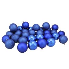 a pile of blue christmas balls sitting on top of a white floor next to each other