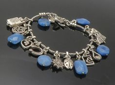 "925 Sterling Silver - Vintage Blue Quartz Assorted Charm Chain Bracelet - BT5747  925 Sterling Silver - Vintage Blue Quartz Assorted Charm Chain Bracelet - BT5747  Jewelry Type:         Bracelet  Metal Type:            925 Silver  Metal Size:             7.5\" Length  1\" Height   Stone Type:            Quartz   Condition:              N/A  Jewelry Weight:     28.1 Grams  PLEASE NOTE: THIS ITEM IS PRE-OWNED. ALTHOUGH MOST ITEMS ARE IN VERY GOOD CONDITION, SOME MAY NEED CLEANING AND/OR MINOR REP Elegant Blue Sterling Silver Charm Bracelet, Elegant Handmade Blue Charm Bracelet, Blue Jewelry With Dangling Charms For Jewelry Making, Handmade Blue Sterling Silver Charm Bracelet, Blue Jewelry With Dangling Charms, Blue Charm Bracelet Jewelry, Blue Dangle Bracelets With Charms, Elegant Blue Nickel Free Charm Bracelet, Blue Charm Bracelet With Dangling Charms As Gift