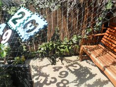 a wooden bench sitting next to a wire fence