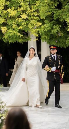 a bride and groom walking down the aisle