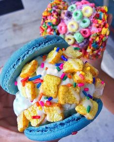 two scoops of ice cream with sprinkles and cereal on top, one is blue