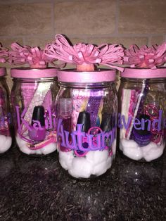 there are four jars with pink decorations in them