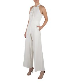 Halter jumpsuit with knot at neck and keyhole. Slight wide leg pant in crepe that has a slight stretch with pockets at the side seams. Zipper at the center back with 2 buttons at back neck. Crepe Jumpsuit, Flare Jumpsuit, Designer Jumpsuits, Lace Jumpsuit, Halter Jumpsuit, Ivory Tops, Jumpsuit With Sleeves, Wide Leg Pant, Mock Neckline