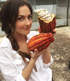 a woman is holding an odd looking food item