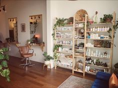 a room filled with lots of plants and shelves full of personal care products on top of them