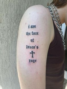 a woman with a tattoo on her arm that says i am the face of love's rage